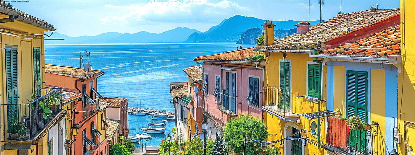 Amalfi coast look-like landscape, Italian town on the sea, terraced houses decorated with flowers. Mediterranean travel concept