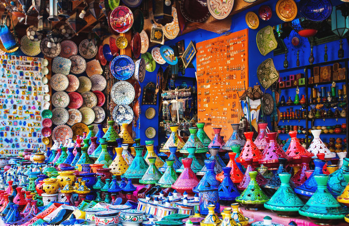 Colored Tajine, plates and pots out of clay on the market of Chefchaouen in Morocco. Moroccan Medina